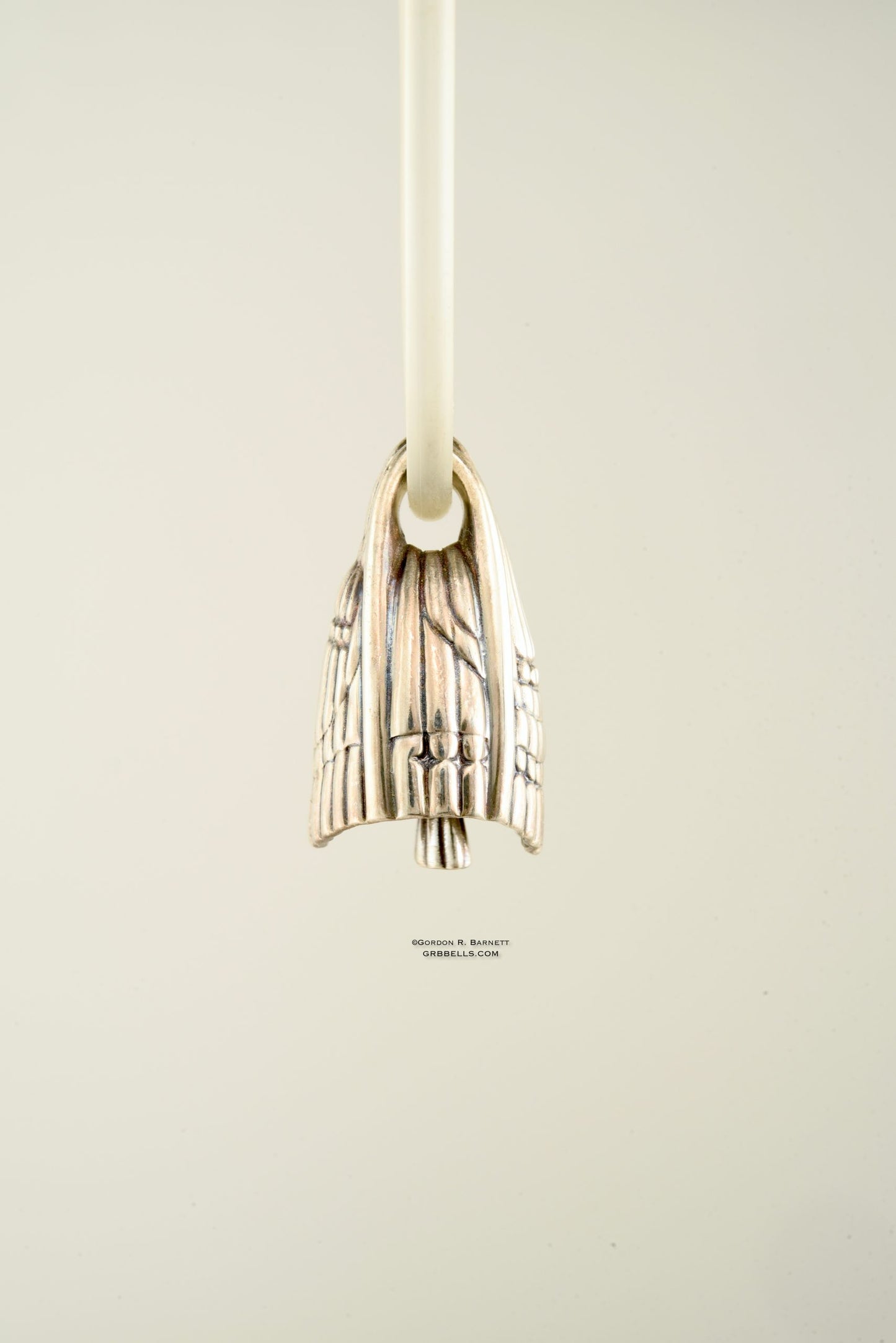 aurora jewelry bell necklace in sterling silver, side view