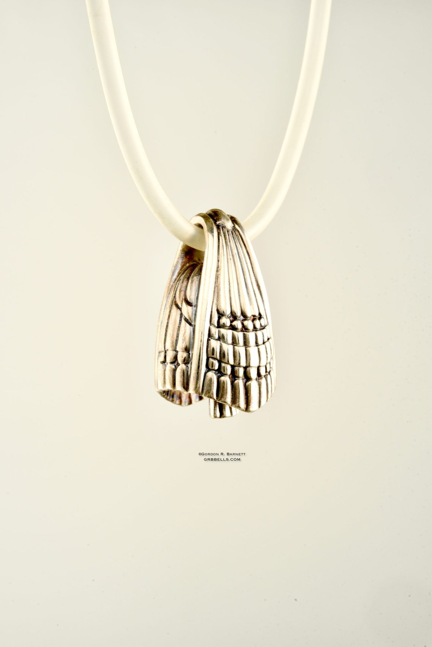 aurora jewelry bell necklace in sterling silver, left side three quarters view