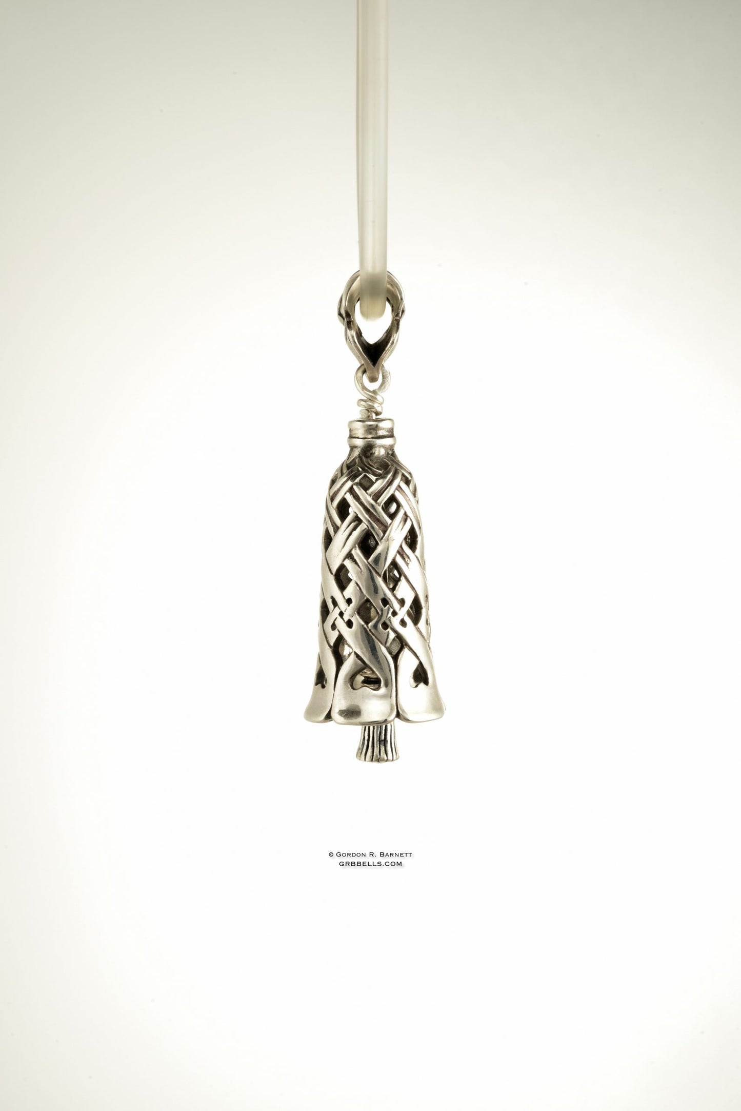 Side view. jewelry bell necklace in sterling silver is handmade pendant is made with lost wax casting, then polished and assembled in Washington state perfect gift for weaver