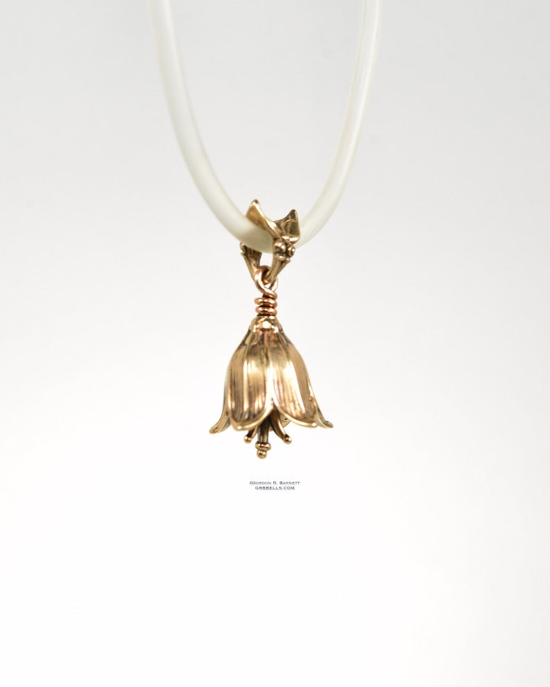 chocolate lily bell necklace in bronze is 30 mm tall. (front three-quarterview) his handmade pendant is made with lost wax casting, then polished and assembled in Washington state. suitable for botanist gardener