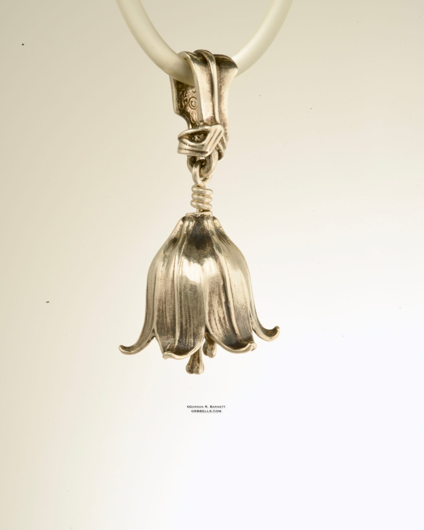 chocolate lily bell necklace in sterling silver is 47 mm tall. (back view) his handmade pendant is made with lost wax casting, then polished and assembled in Washington state. suitable for botanist gardener