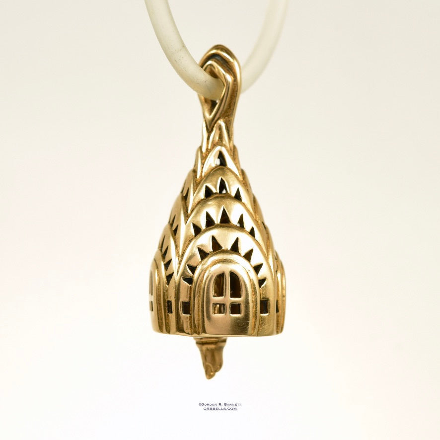 chrisler building bell necklace in bronze is 30 mm tall. (left three-quarter view) his handmade pendant is made with lost wax casting, then polished and assembled in Washington state. suitable for architect