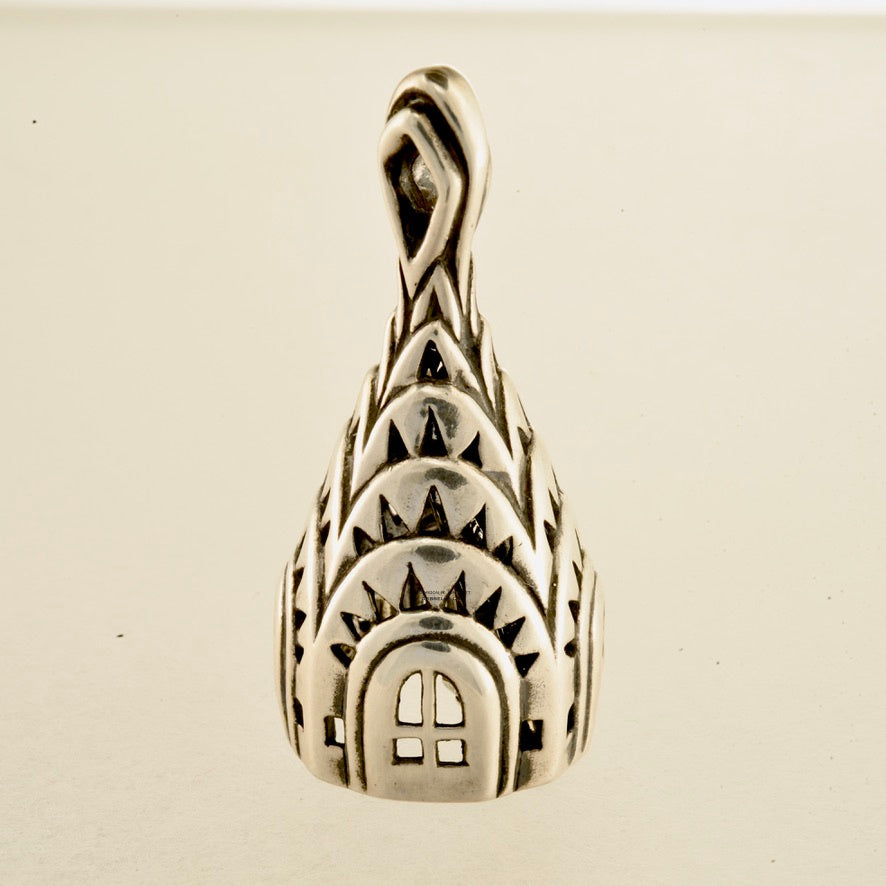 chrisler building bell necklace in sterling silver is 45 mm tall. (side view sitting) his handmade pendant is made with lost wax casting, then polished and assembled in Washington state. suitable for architect