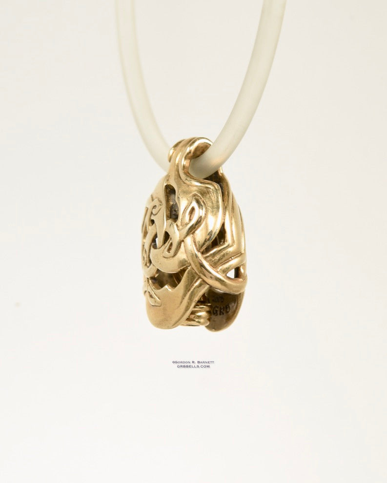CELTIC TRISKELE jewelry bell necklace right three-quarter view in bronze is a handmade pendant in bronze is made with lost wax casting, then polished and assembled in Washington state perfect gift for celtic symbol
