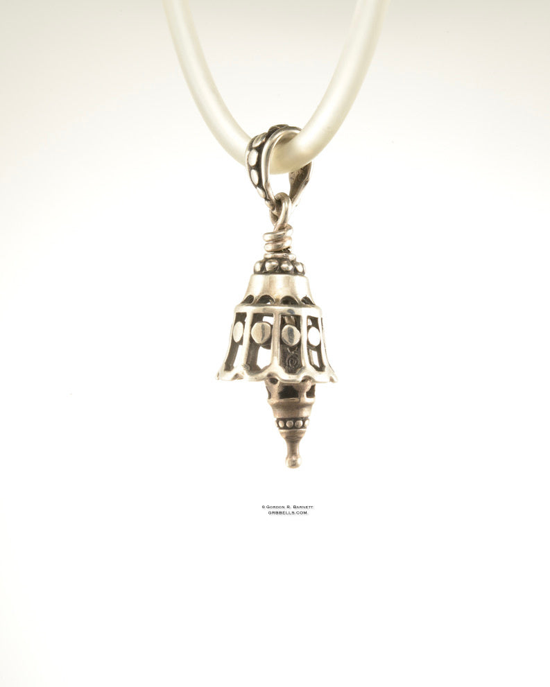 Bell Necklace in bronzeis 30 mm tall, (left three-quarter view) This handmade pendant is made with lost wax casting, then polished and assembled in Washington state. suitable for quiet voices